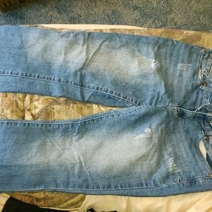 Distressed bootcut blue jeans